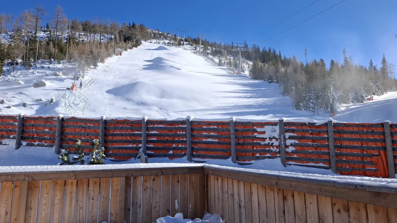 Blick vom Balkon des Chalets Panorama auf die verschneite Piste
